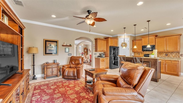 living room with arched walkways, ceiling fan, recessed lighting, light tile patterned flooring, and ornamental molding