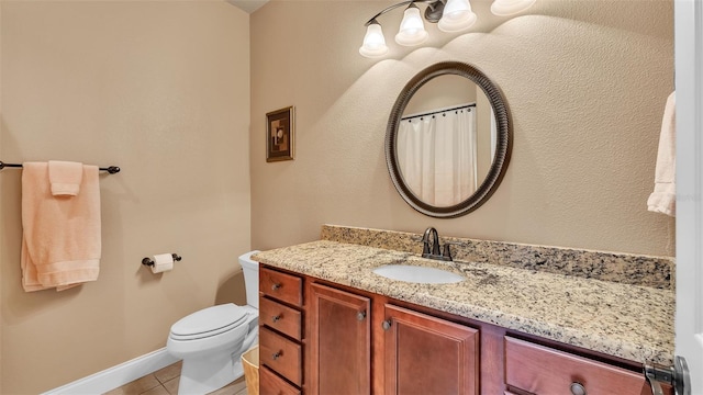 full bathroom featuring tile patterned floors, vanity, toilet, and baseboards