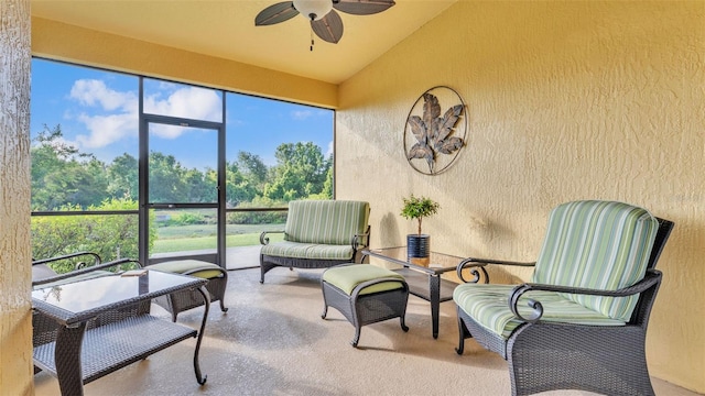 sunroom / solarium with a ceiling fan, lofted ceiling, healthy amount of natural light, and an outdoor living space