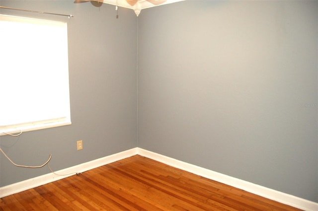 255 S Pennsylvania Ave, Lake Alfred, FL 33850 - spare room with wood finished floors, baseboards, and a ceiling fan