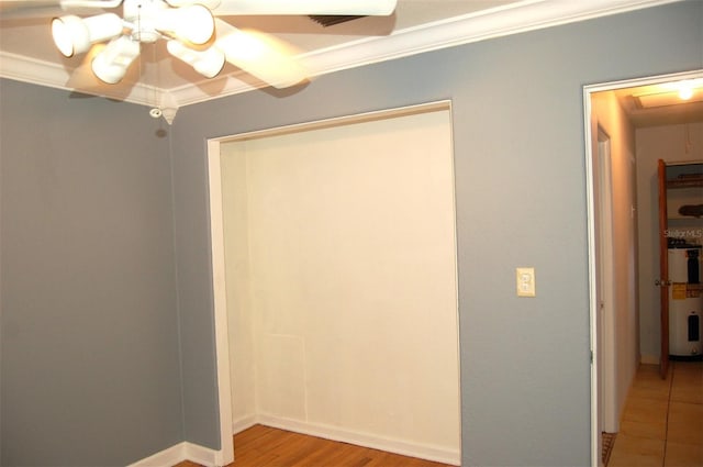 255 S Pennsylvania Ave, Lake Alfred, FL 33850 - unfurnished bedroom with electric water heater, a chandelier, crown molding, light wood-type flooring, and a ceiling fan