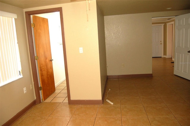 255 S Pennsylvania Ave, Lake Alfred, FL 33850 - hallway with light tile patterned flooring and baseboards