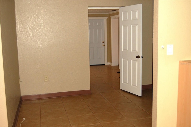 255 S Pennsylvania Ave, Lake Alfred, FL 33850 - unfurnished room with baseboards, tile patterned floors, crown molding, and a textured wall