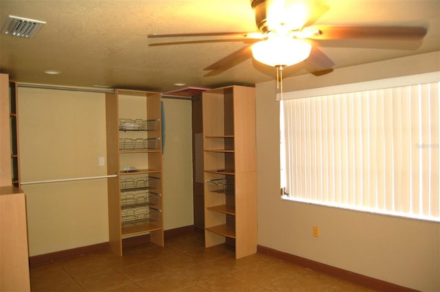 255 S Pennsylvania Ave, Lake Alfred, FL 33850 - unfurnished bedroom featuring baseboards, tile patterned floors, a closet, and a ceiling fan