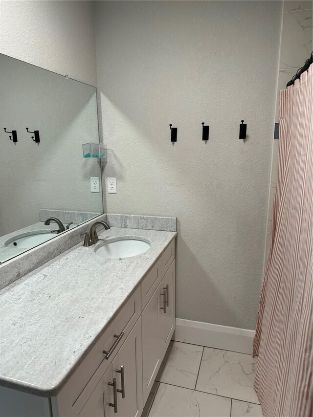 1217 King Ave, Lakeland, FL 33803 - full bathroom featuring marble finish flooring, baseboards, and vanity