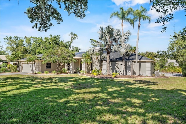 7313 Crape Myrtle Way, Sarasota, FL 34241 - view of front facade with a front yard, an attached garage, stucco siding, solar panels, and concrete driveway