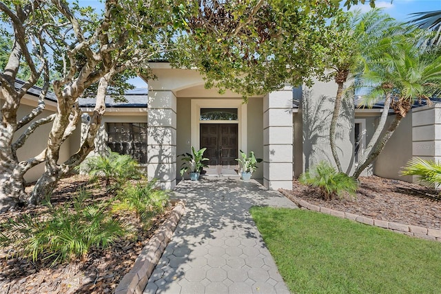 7313 Crape Myrtle Way, Sarasota, FL 34241 - view of front of house with stucco siding, solar panels, and french doors