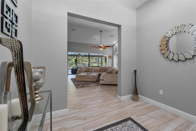 7313 Crape Myrtle Way, Sarasota, FL 34241 - hall featuring baseboards, a high ceiling, and light wood finished floors