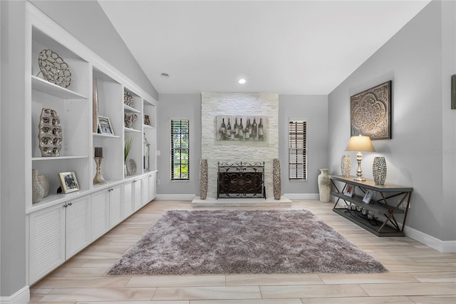 7313 Crape Myrtle Way, Sarasota, FL 34241 - living area featuring vaulted ceiling, a fireplace, light wood-style floors, baseboards, and recessed lighting