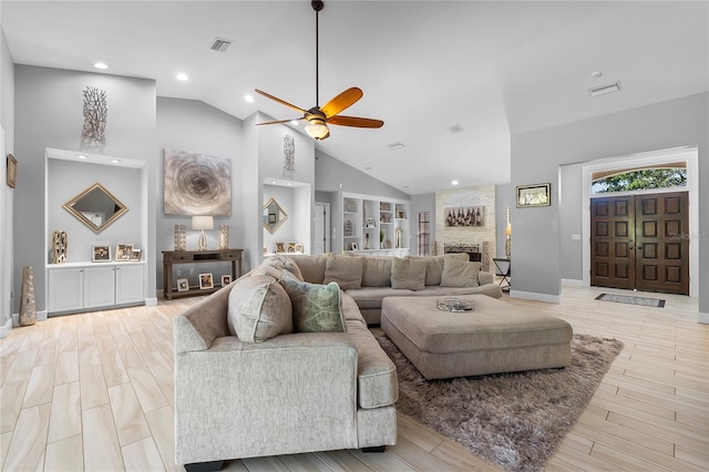7313 Crape Myrtle Way, Sarasota, FL 34241 - living area with ceiling fan, a fireplace, high vaulted ceiling, light wood-type flooring, and baseboards