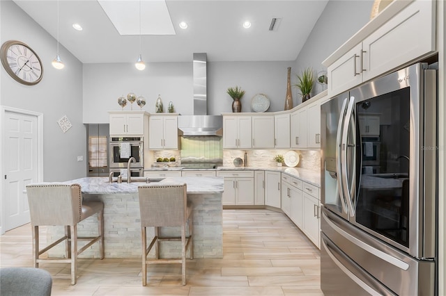 7313 Crape Myrtle Way, Sarasota, FL 34241 - kitchen with wall chimney range hood, backsplash, a sink, white cabinetry, and a towering ceiling