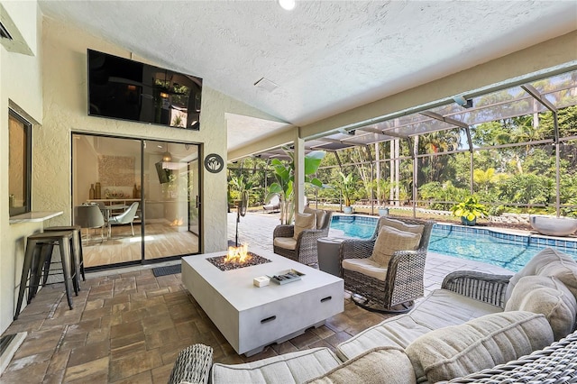 7313 Crape Myrtle Way, Sarasota, FL 34241 - view of patio featuring an outdoor pool, an outdoor living space with a fire pit, glass enclosure, and a bar