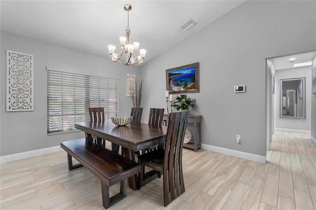7313 Crape Myrtle Way, Sarasota, FL 34241 - dining area with a chandelier, baseboards, light wood-style floors, and lofted ceiling