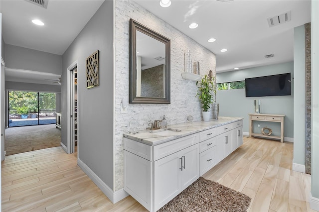 7313 Crape Myrtle Way, Sarasota, FL 34241 - hallway with a sink, light wood finished floors, baseboards, and recessed lighting
