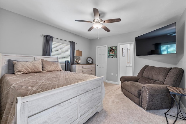 7313 Crape Myrtle Way, Sarasota, FL 34241 - bedroom with light colored carpet, ceiling fan, baseboards, and ensuite bathroom