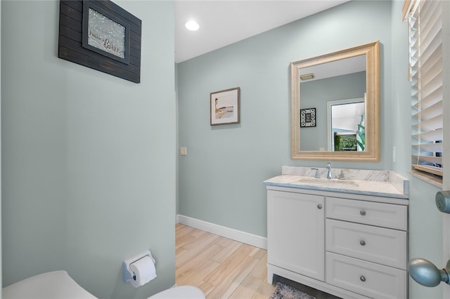 7313 Crape Myrtle Way, Sarasota, FL 34241 - half bathroom with toilet, healthy amount of natural light, wood finished floors, and baseboards