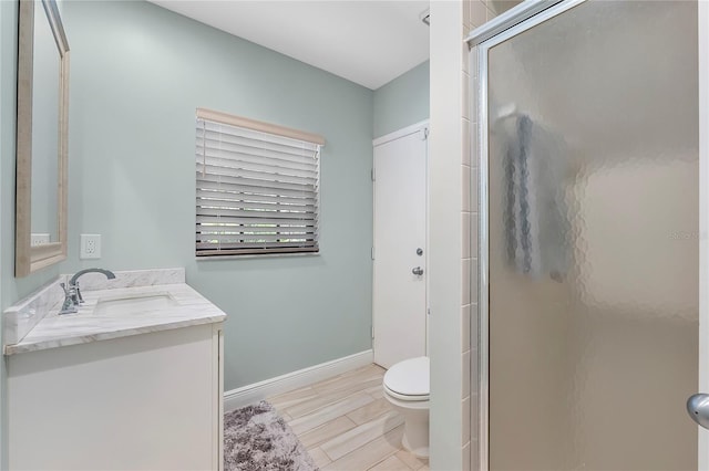 7313 Crape Myrtle Way, Sarasota, FL 34241 - bathroom with a stall shower, toilet, vanity, baseboards, and wood finished floors