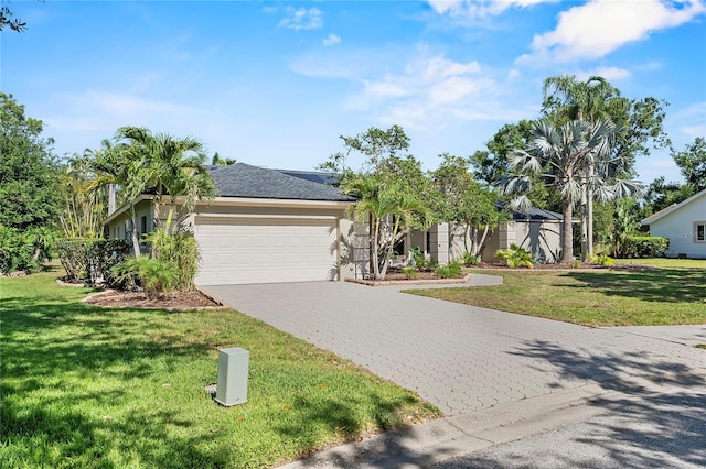 7313 Crape Myrtle Way, Sarasota, FL 34241 - view of front of home featuring an attached garage, decorative driveway, a front lawn, and stucco siding