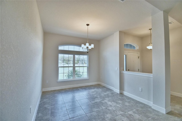 unfurnished room with a chandelier, a textured wall, tile patterned floors, and baseboards