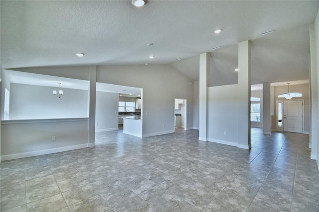 unfurnished living room featuring plenty of natural light, high vaulted ceiling, recessed lighting, and baseboards