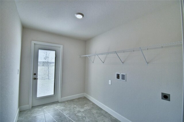 clothes washing area featuring hookup for an electric dryer, washer hookup, baseboards, and light tile patterned floors