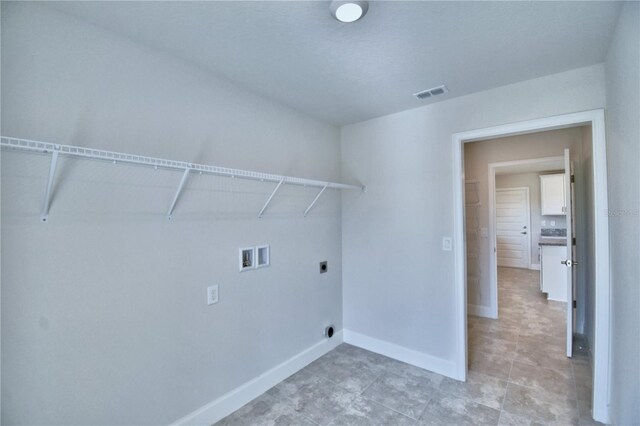 laundry area featuring hookup for a washing machine, electric dryer hookup, and baseboards