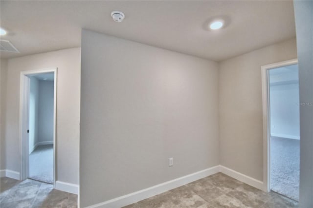 spare room with baseboards and a smoke detector