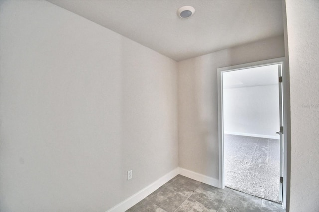 spare room featuring baseboards
