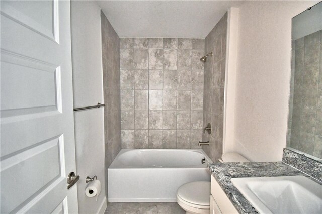 bathroom featuring vanity, toilet, and shower / tub combination
