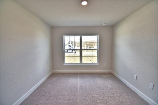 empty room with carpet and baseboards