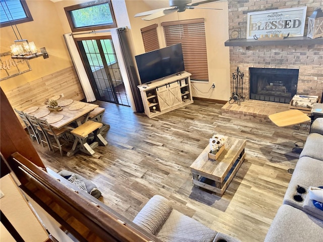 5619 Antler Trl, Lakeland, FL 33811 - living room featuring a ceiling fan, a fireplace, wainscoting, and wood finished floors