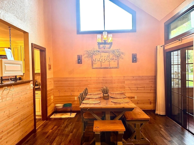 5619 Antler Trl, Lakeland, FL 33811 - dining space featuring wainscoting, dark wood-style flooring, high vaulted ceiling, and a chandelier
