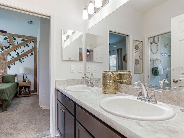 full bath with a sink, double vanity, a ceiling fan, and visible vents