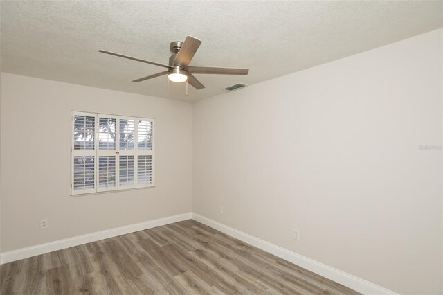 4008 S Carlisle Rd, Lakeland, FL 33813 - spare room featuring wood finished floors, ceiling fan, and a textured ceiling