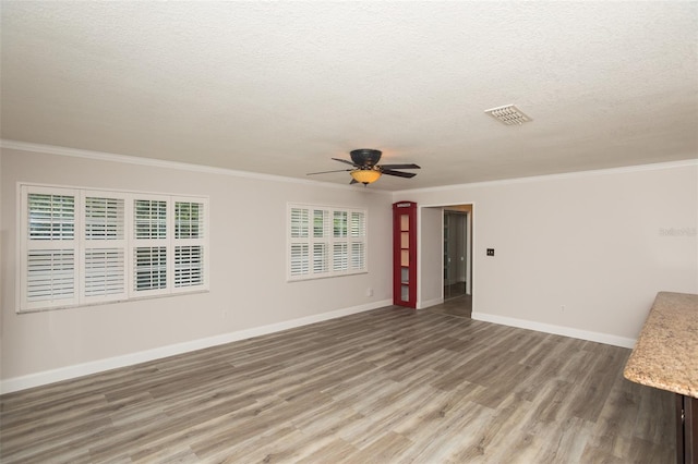 4008 S Carlisle Rd, Lakeland, FL 33813 - unfurnished room featuring light wood finished floors, ceiling fan, crown molding, and a textured ceiling