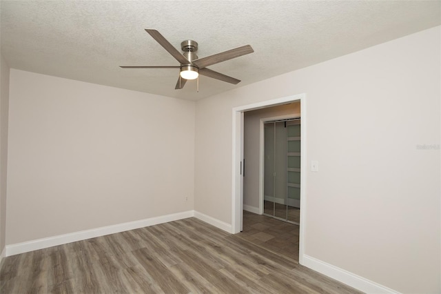 4008 S Carlisle Rd, Lakeland, FL 33813 - spare room with wood finished floors, ceiling fan, and a textured ceiling