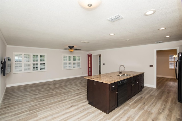 4008 S Carlisle Rd, Lakeland, FL 33813 - kitchen with black appliances, light wood-style flooring, a center island with sink, healthy amount of natural light, and recessed lighting