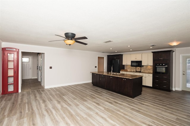 4008 S Carlisle Rd, Lakeland, FL 33813 - kitchen with black appliances, decorative backsplash, an island with sink, ceiling fan, and wood finished floors