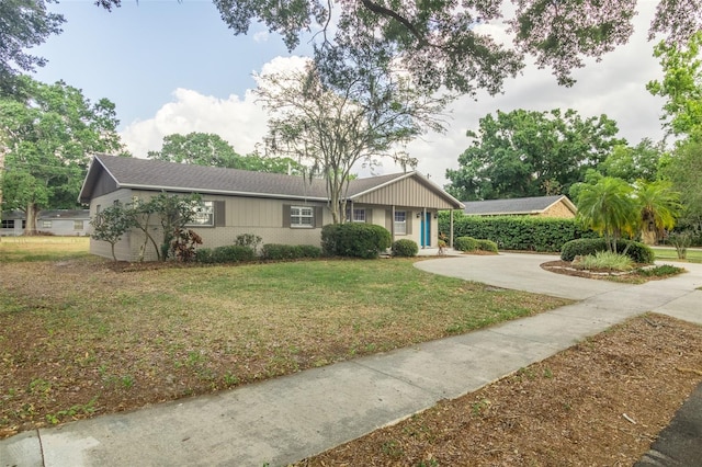 4008 S Carlisle Rd, Lakeland, FL 33813 - ranch-style house with a front lawn, driveway, and brick siding