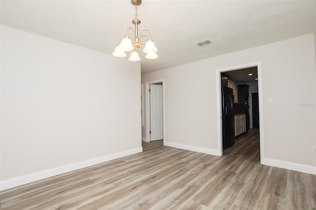 4008 S Carlisle Rd, Lakeland, FL 33813 - unfurnished room featuring a chandelier and light wood finished floors