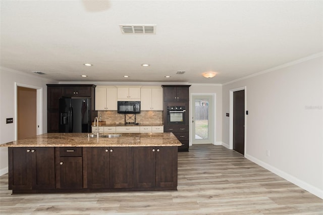 4008 S Carlisle Rd, Lakeland, FL 33813 - kitchen featuring black appliances, backsplash, ornamental molding, a large island, and light wood-style flooring