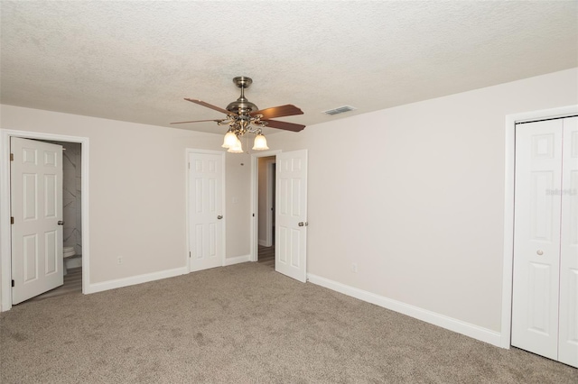 4008 S Carlisle Rd, Lakeland, FL 33813 - unfurnished bedroom with carpet, a textured ceiling, ensuite bathroom, and a ceiling fan