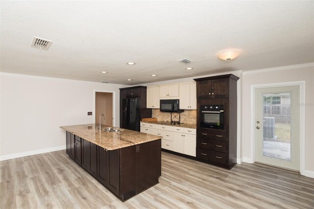4008 S Carlisle Rd, Lakeland, FL 33813 - kitchen featuring black appliances, backsplash, light wood-type flooring, crown molding, and light stone countertops