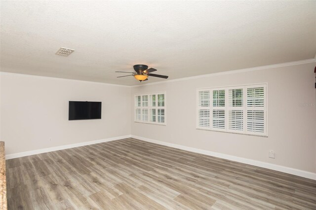4008 S Carlisle Rd, Lakeland, FL 33813 - unfurnished room featuring light wood-style floors, a ceiling fan, ornamental molding, and a textured ceiling