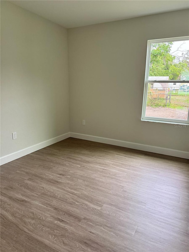 625 W 9th St, Lakeland, FL 33805 - unfurnished room with baseboards and dark wood-style floors