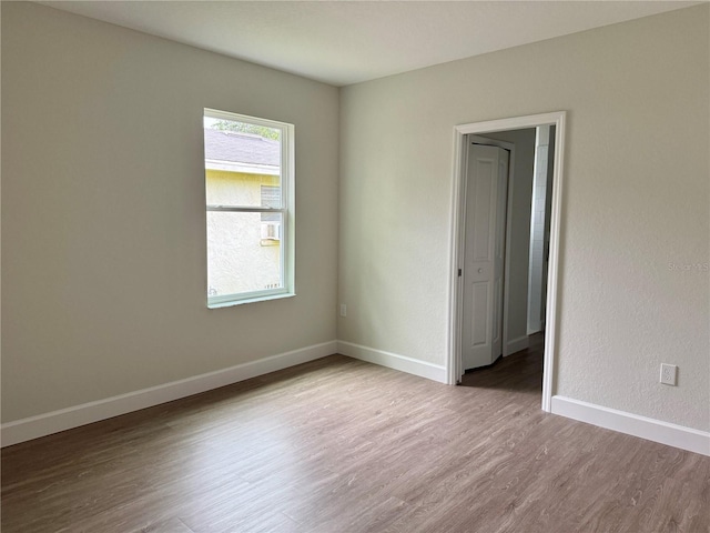 625 W 9th St, Lakeland, FL 33805 - spare room featuring wood finished floors and baseboards