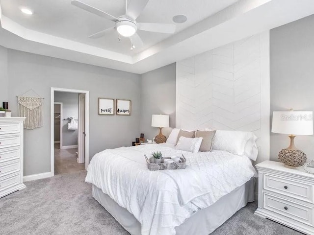 5418 Duxford Cir, Saint Cloud, FL 34771 - carpeted bedroom featuring baseboards, a raised ceiling, and a ceiling fan