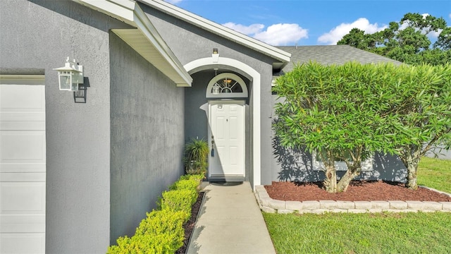 242 Kings Pond Ave SW, Winter Haven, FL 33880 - property entrance with stucco siding and roof with shingles