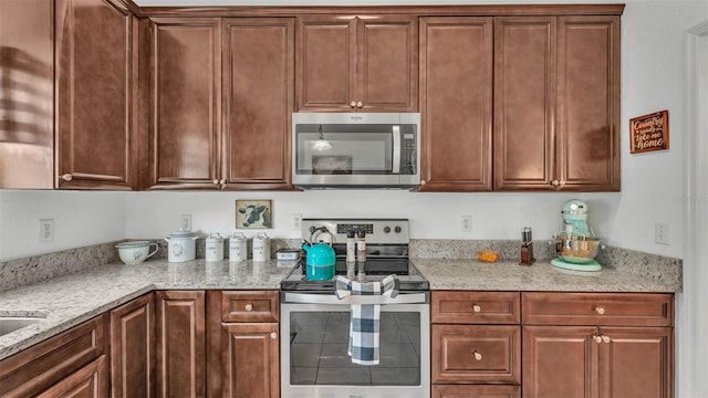 242 Kings Pond Ave SW, Winter Haven, FL 33880 - kitchen featuring stainless steel appliances and light stone counters