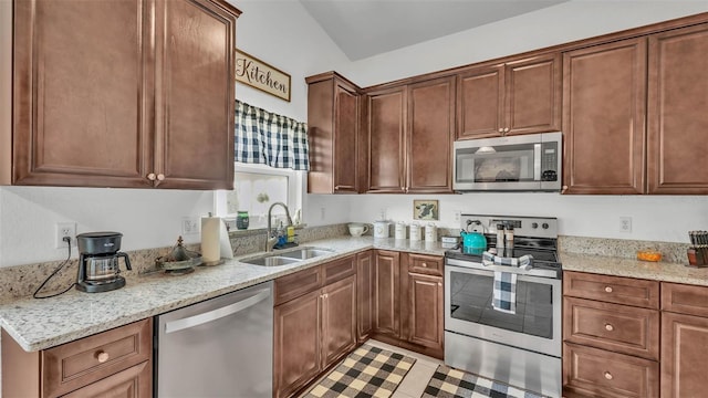 242 Kings Pond Ave SW, Winter Haven, FL 33880 - kitchen with appliances with stainless steel finishes, a sink, and light stone countertops